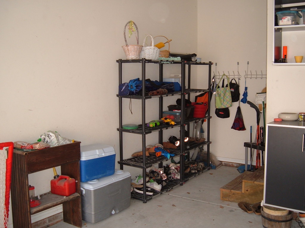 Organized garage storage shelving with stacked plastic storage bins