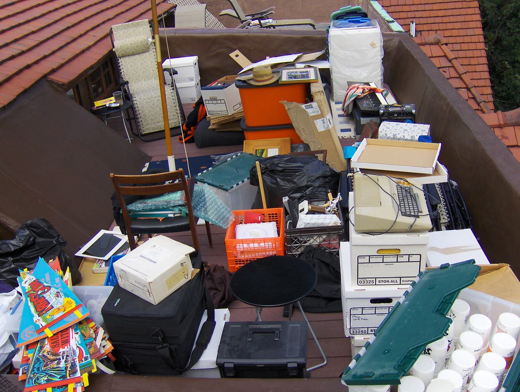 Sorting through years of accumulated household clutter while cleaning an attic