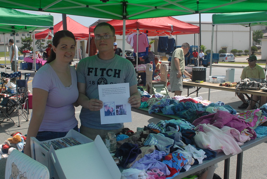 Community yard sale with tables of priced items for sale